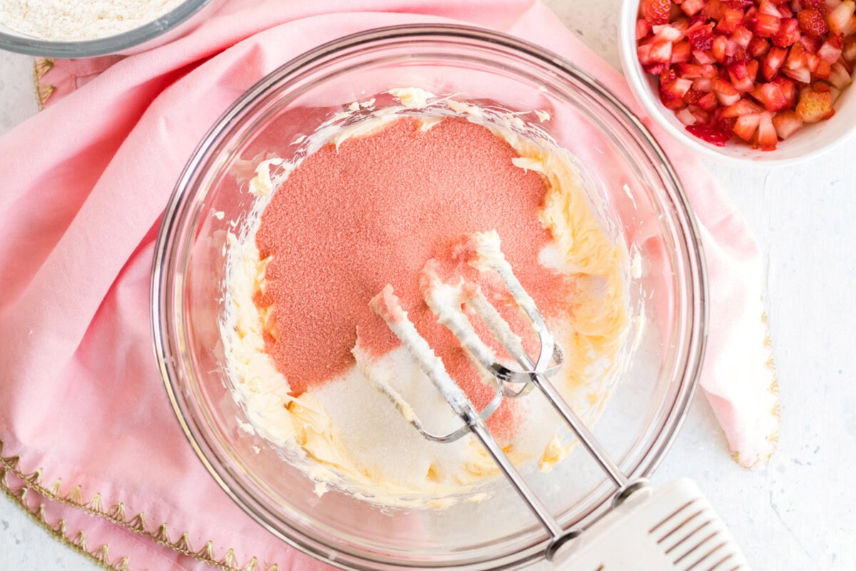 Sugar and gelatin powder added to the bowl of butter