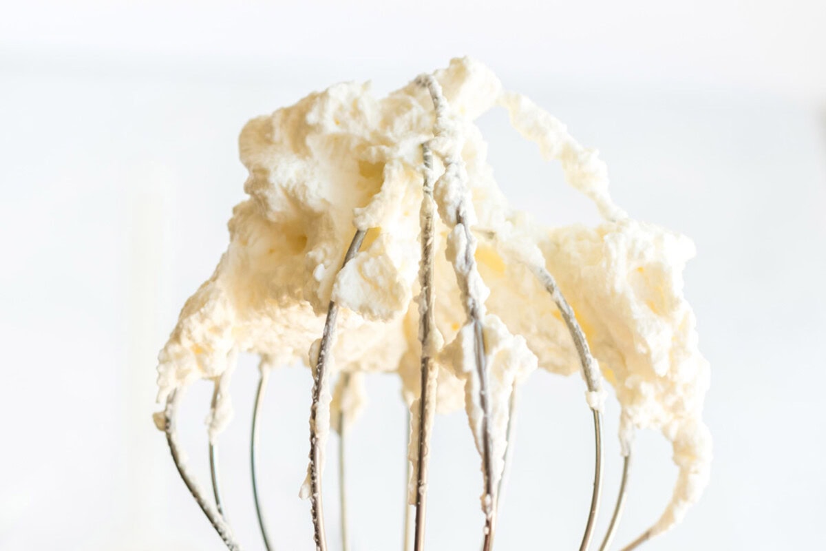 Whipped heavy cream on a whisk attachment