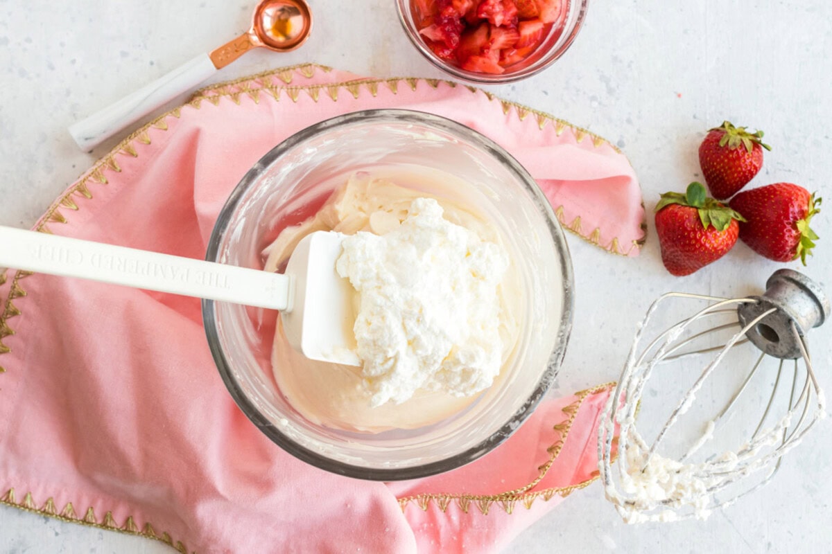 Whipped cream being mixed into the cream cheese mixture 