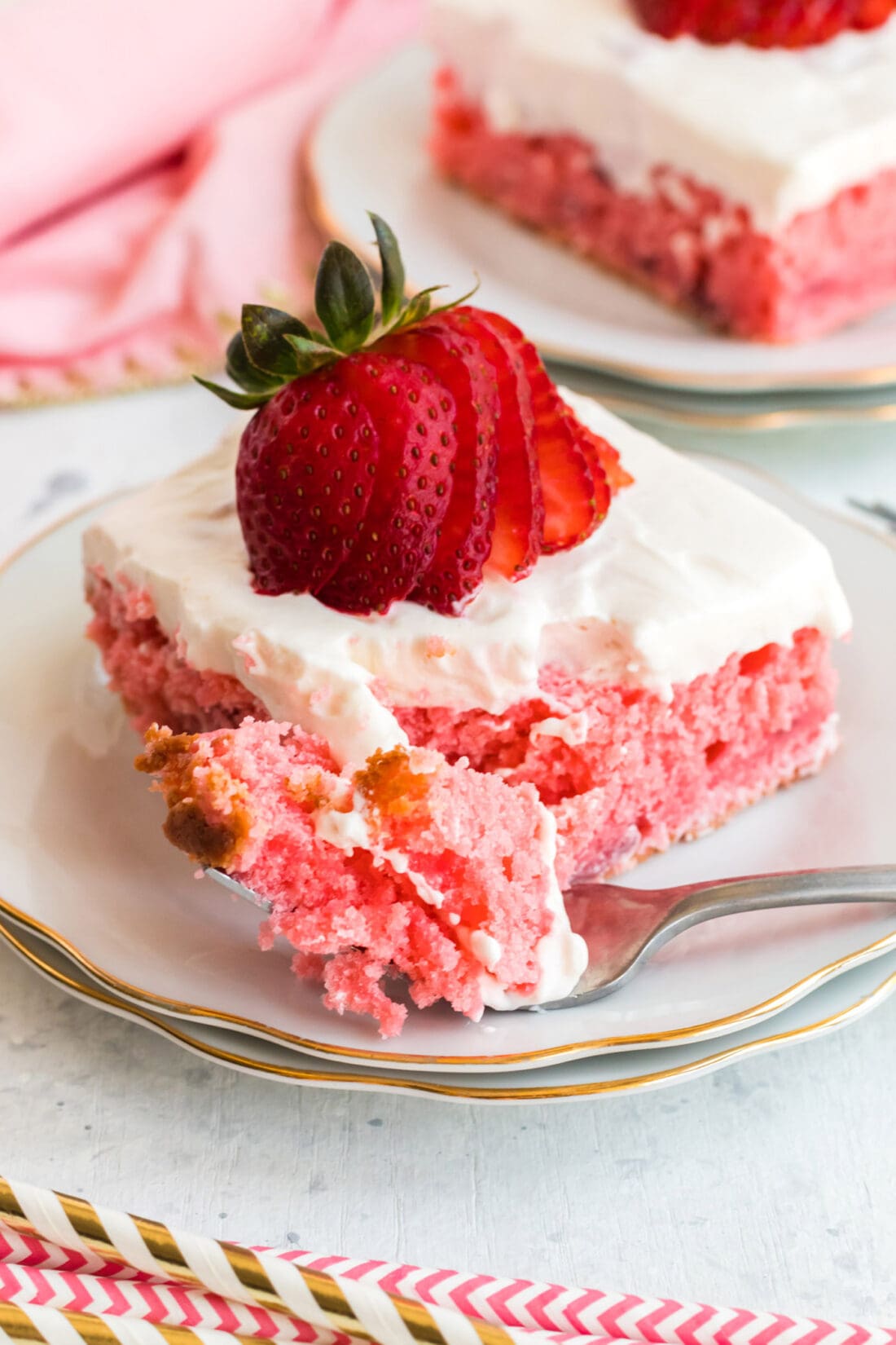 Strawberry Cake on a plate with a piece on a fork