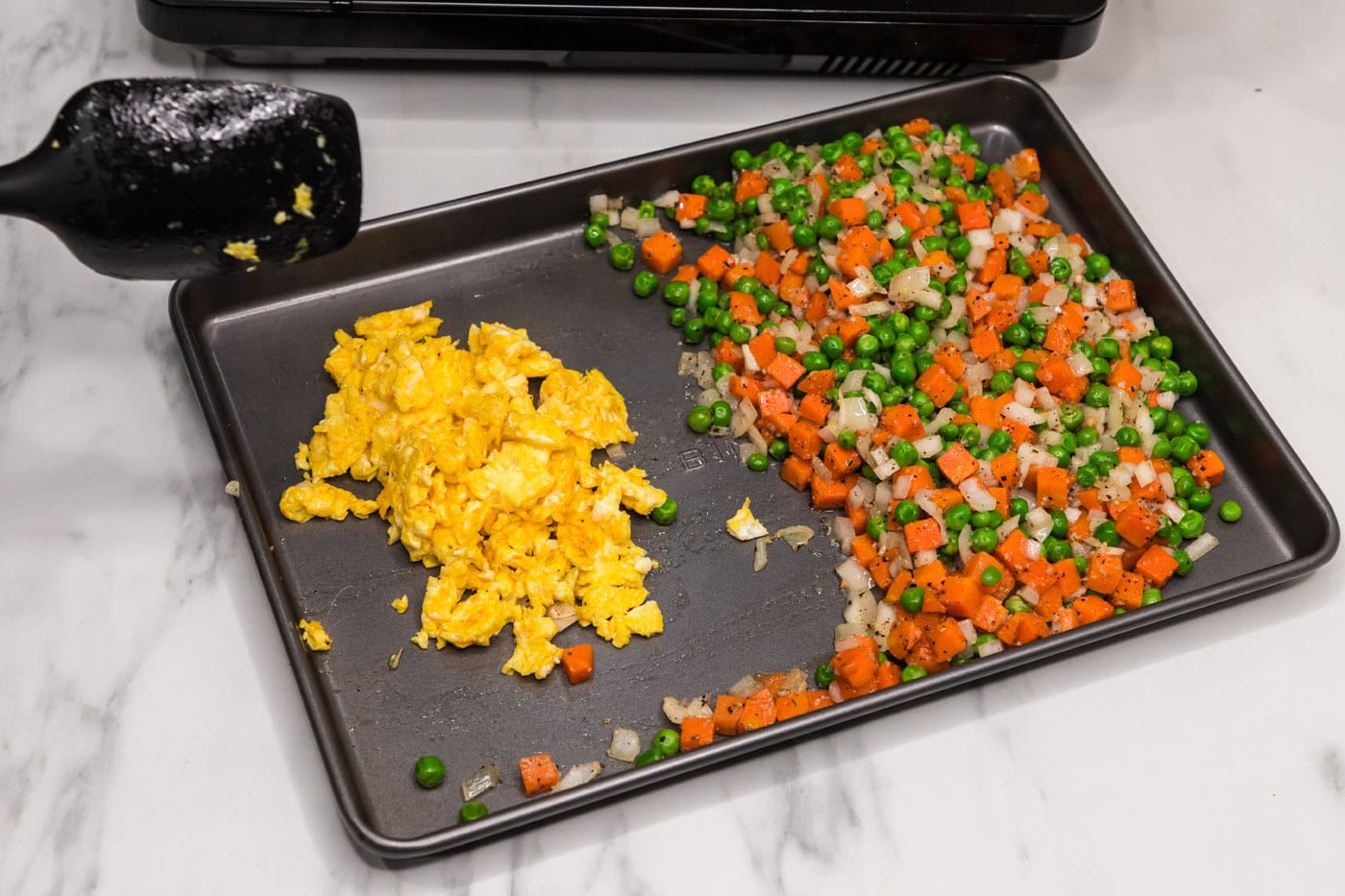scrambled eggs and stir fried vegetables on a pan