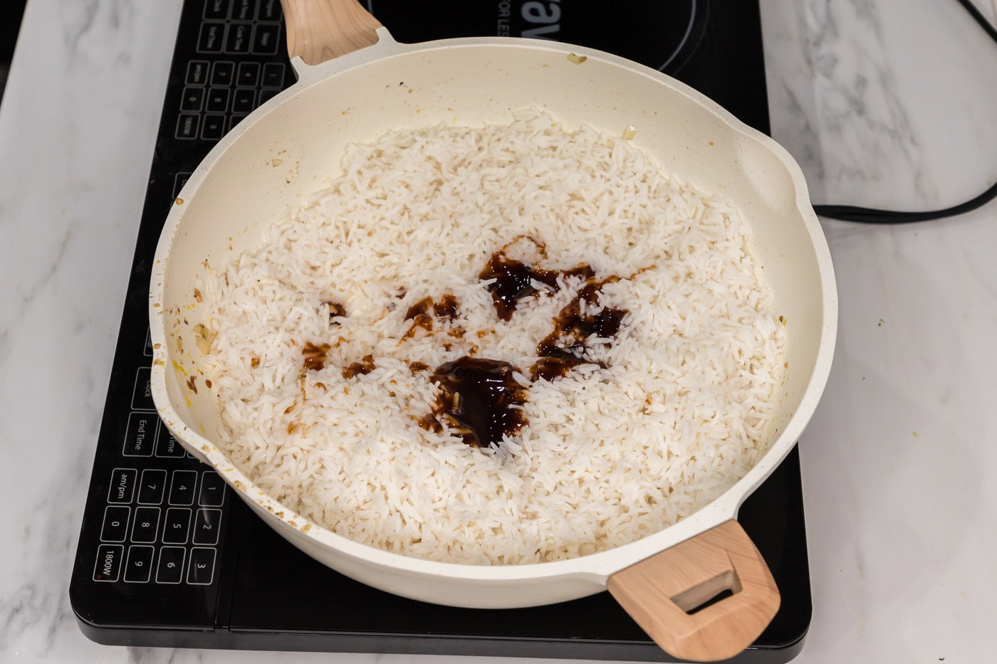 soy sauce and oyster sauce added to skillet with rice