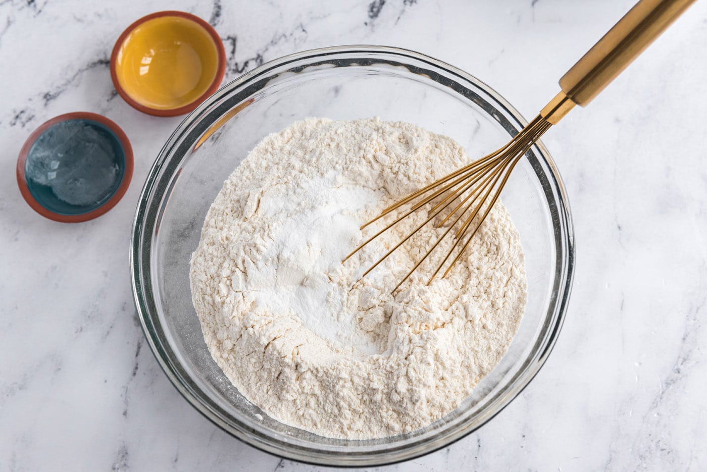 whisking flour, baking powder, and salt in a bowl