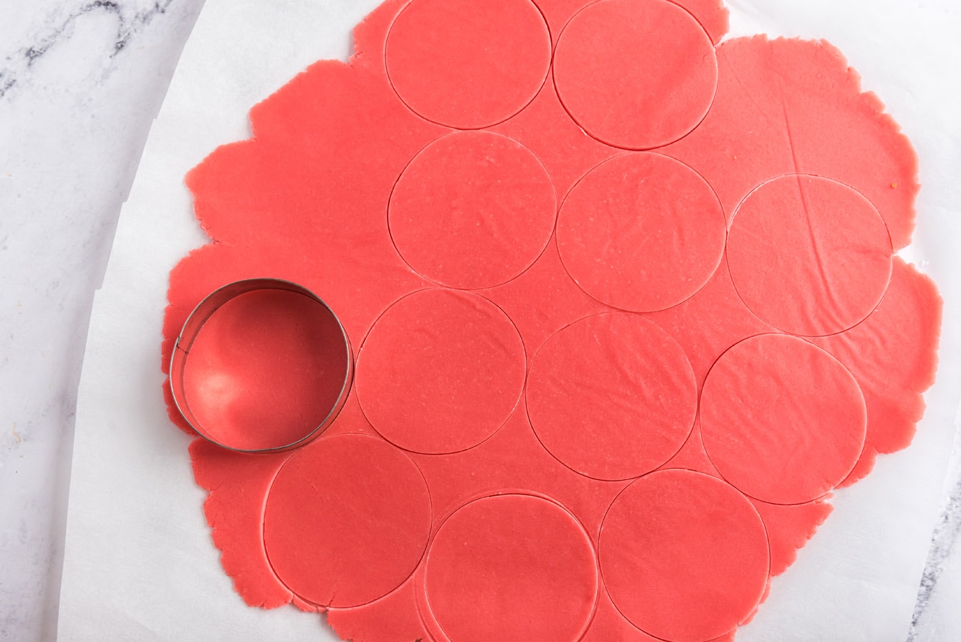 cutting circles out of sugar cookie dough