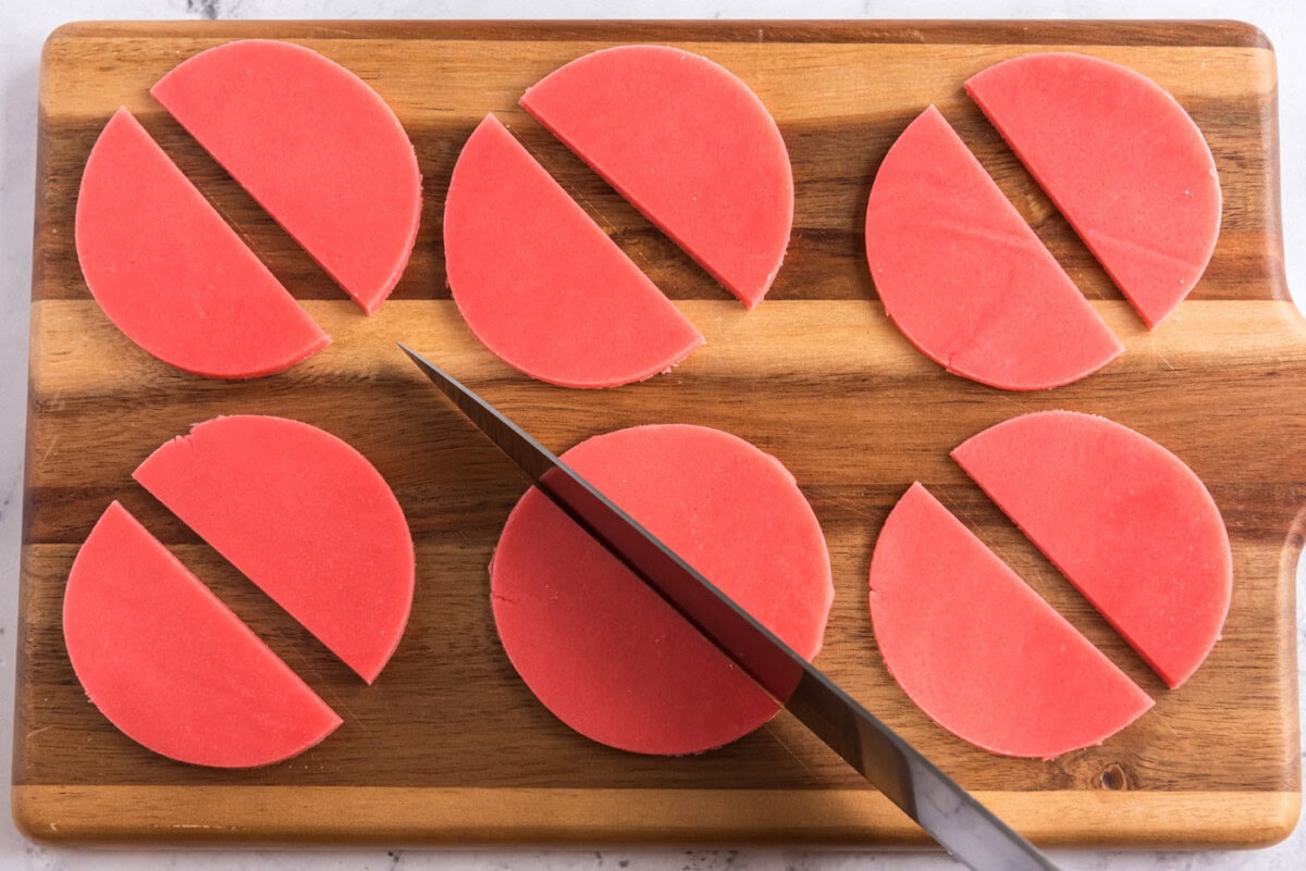 slicing sugar cookie dough discs in half