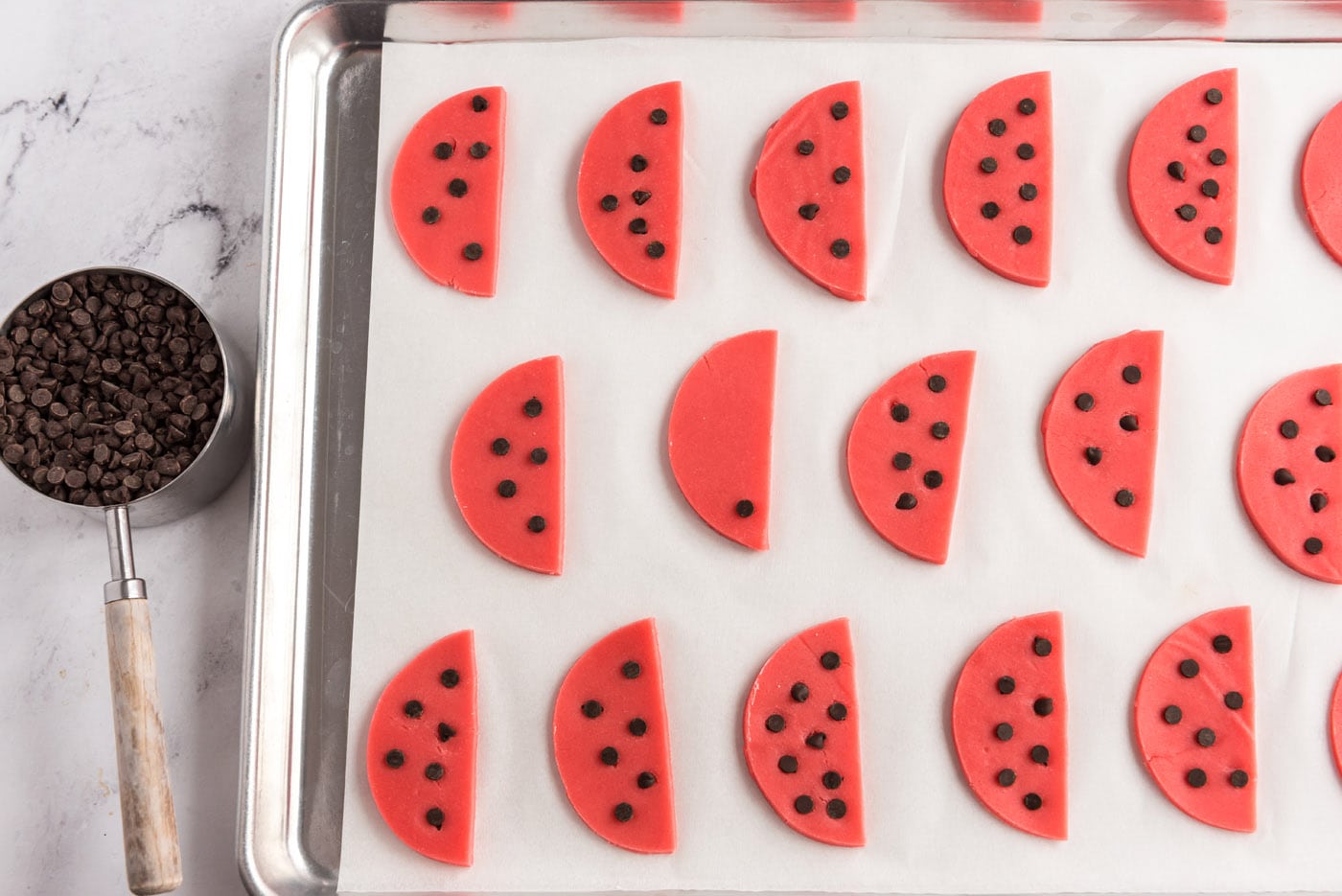 dotting watermelon cookie dough with chocolate chips