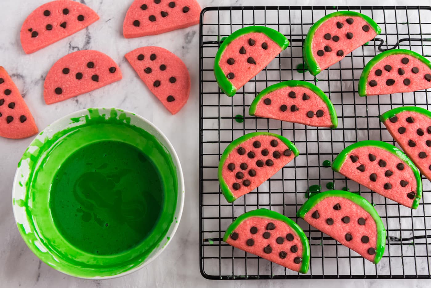 watermelon cookie slices dipping in green glaze