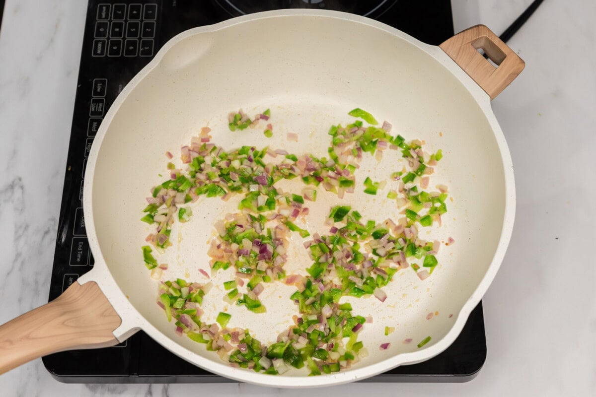 sauteed bell peppers, onion, and garlic in a skillet