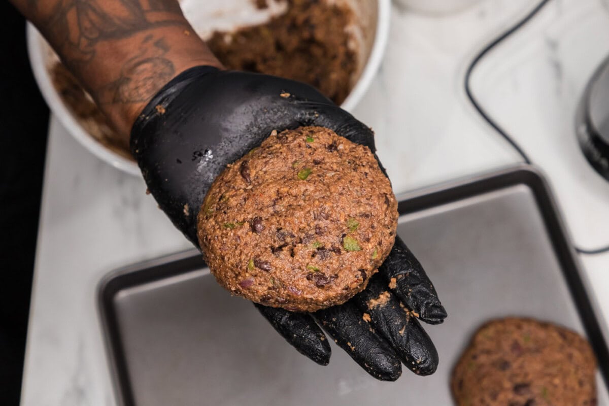 hand holding black bean burger patty
