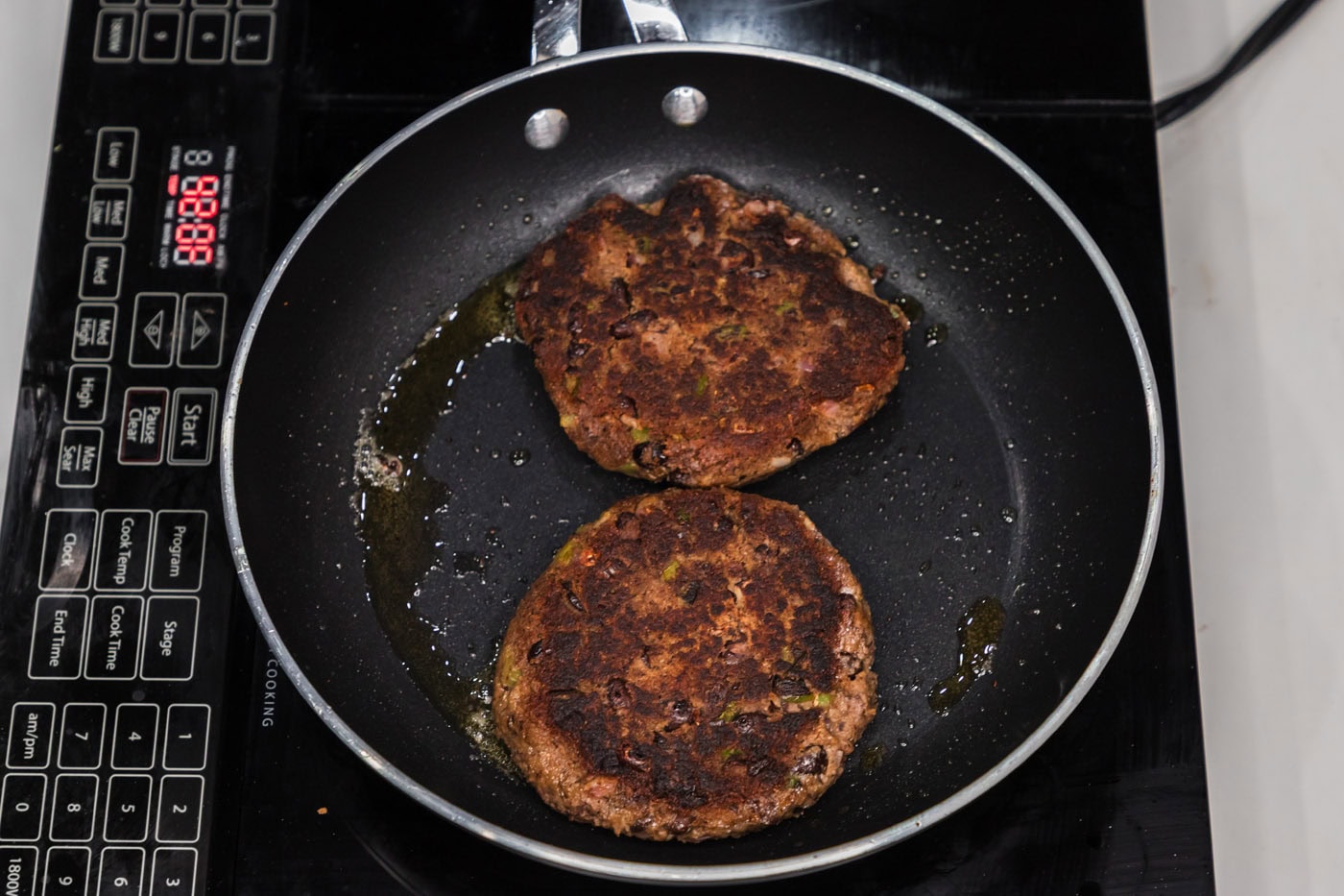 cooked black bean burgers in a skillet