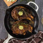 Two Bone in Ribeyes in a skillet