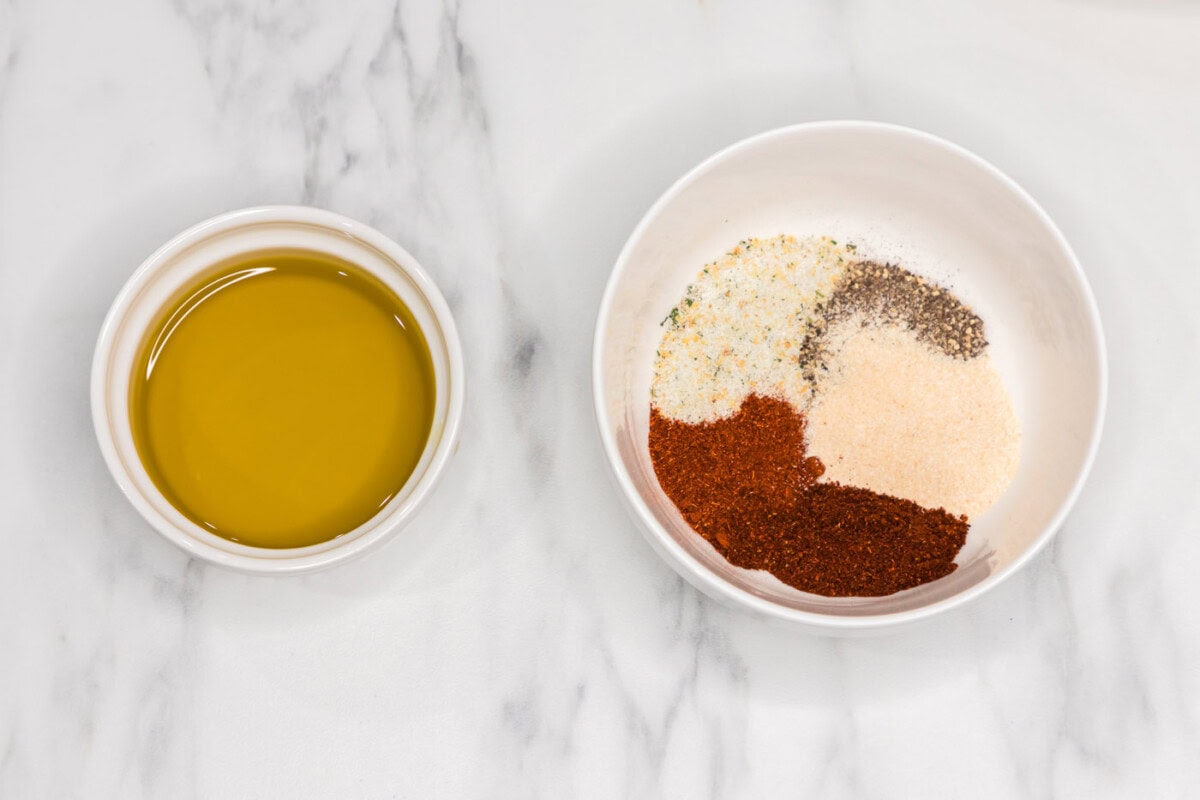 oil in a bowl next to seasoning blend