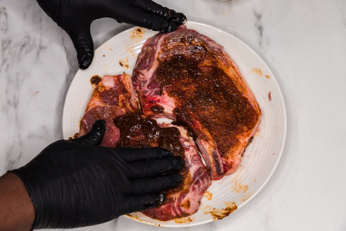 rubbing ribeye steaks with a wet rub