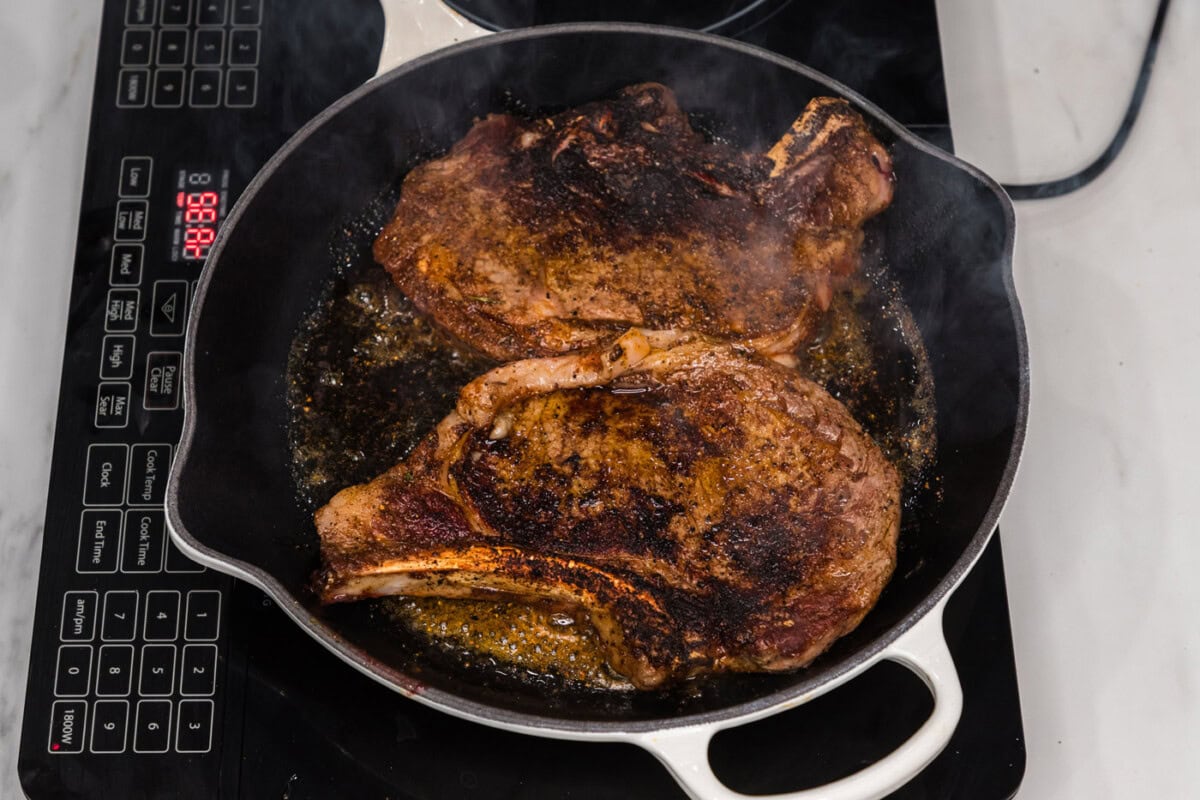 seared ribeye steaks in a skillet