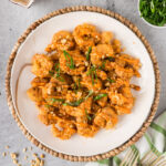 Plate of Boom Boom Shrimp topped with green onion and sesame seeds