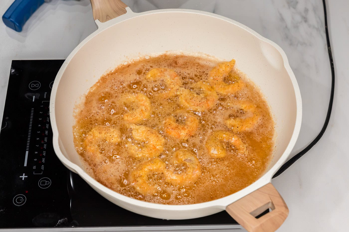 fried shrimp in a skillet with oil