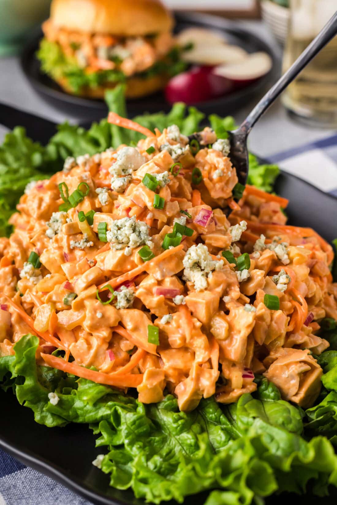 Buffalo Chicken Salad on a bed of lettuce with a spoon in it