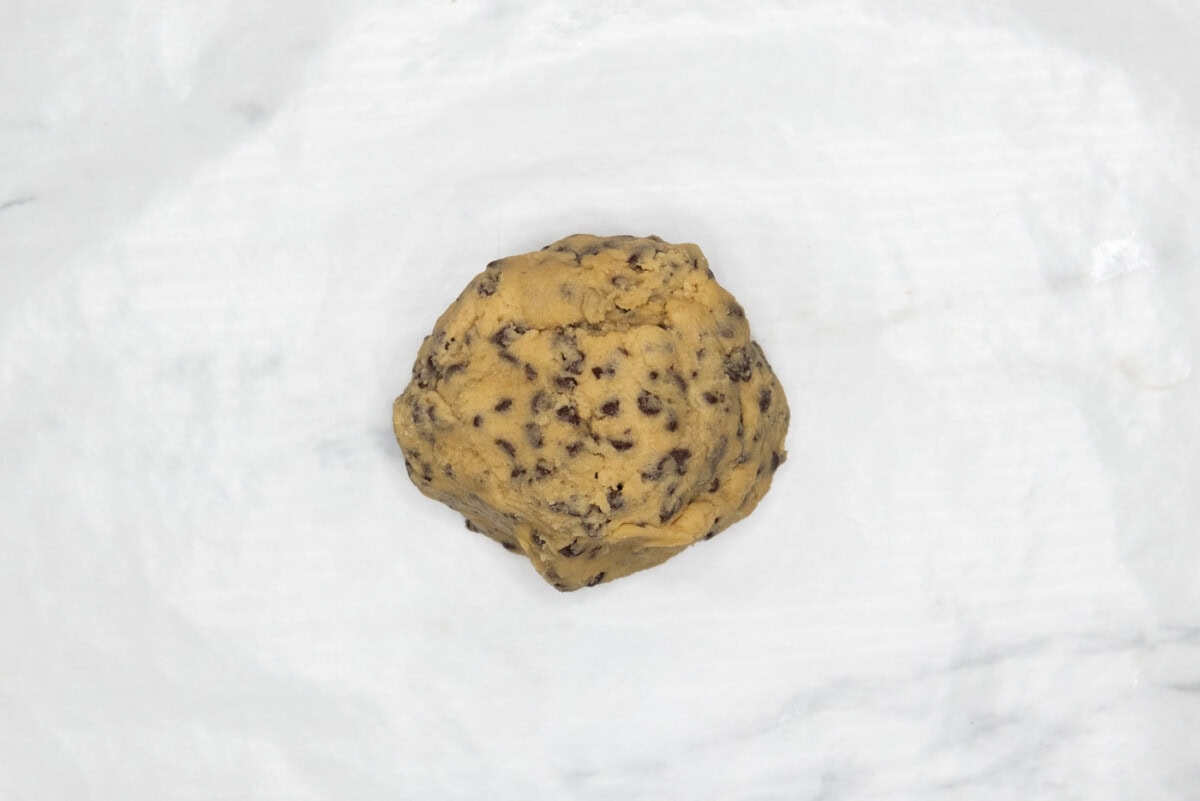 chocolate chip cookie dough ball in parchment paper