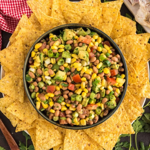 Bowl of Cowboy Caviar surrounded by tortilla chips