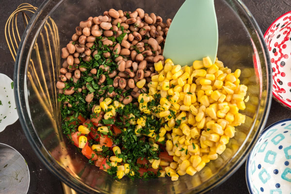 stirring cowboy caviar ingredients together in a bowl