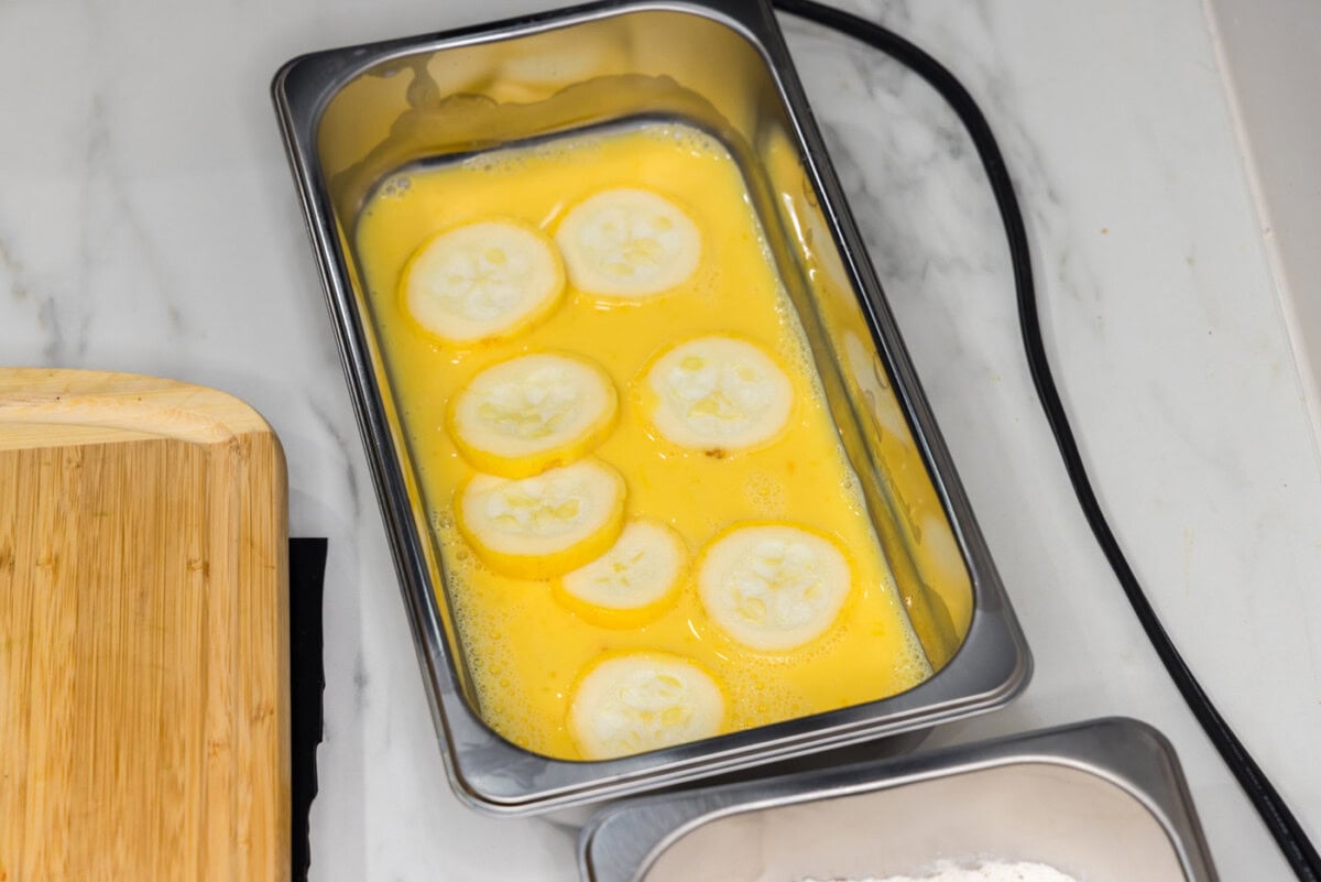 yellow squash coins dipped into egg and milk mixture