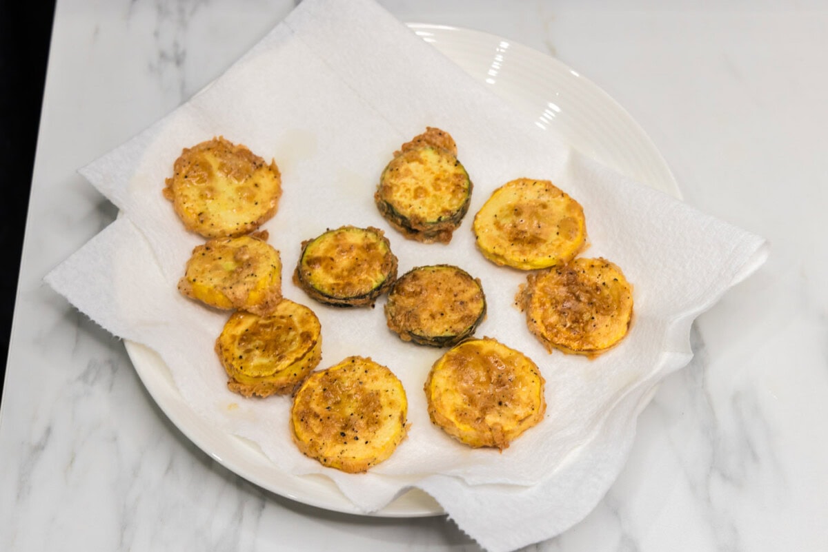 fried squash draining on paper towels