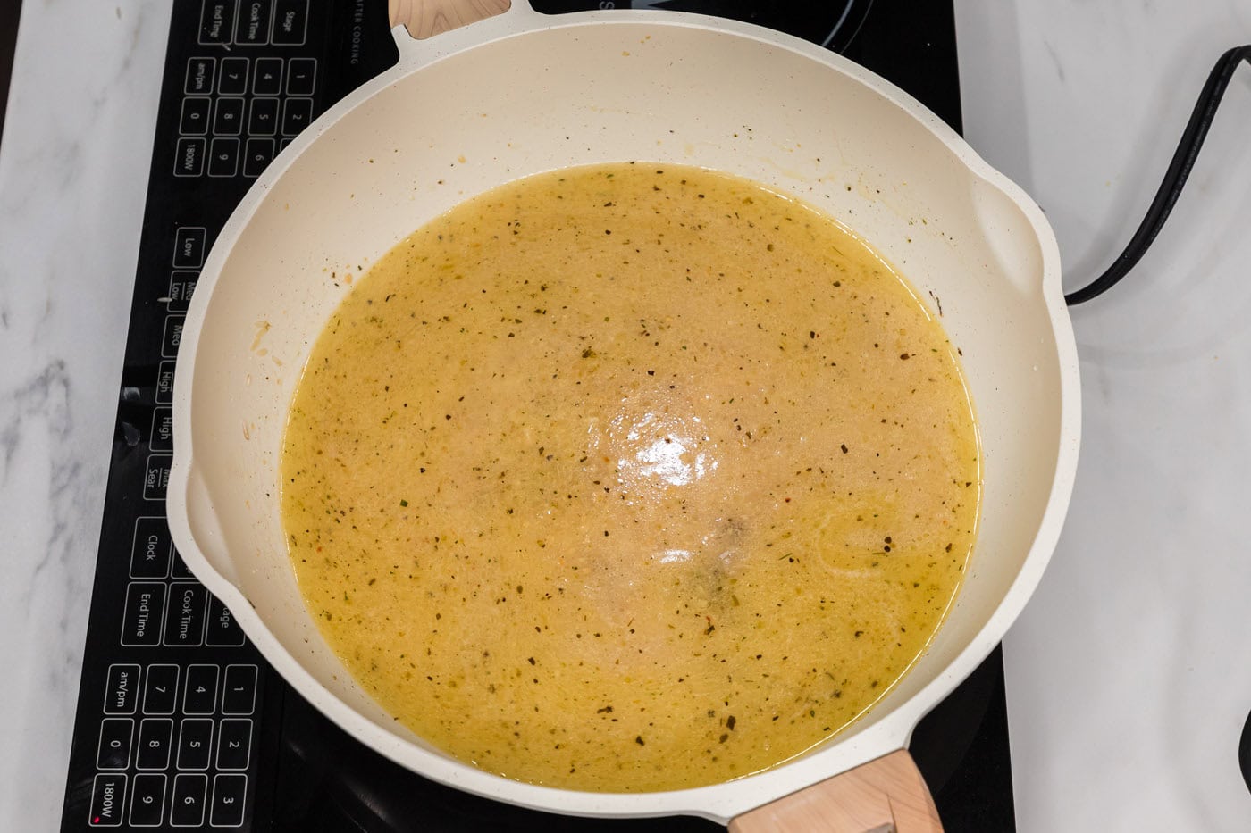 garlic butter rice in a skillet cooking down with liquid