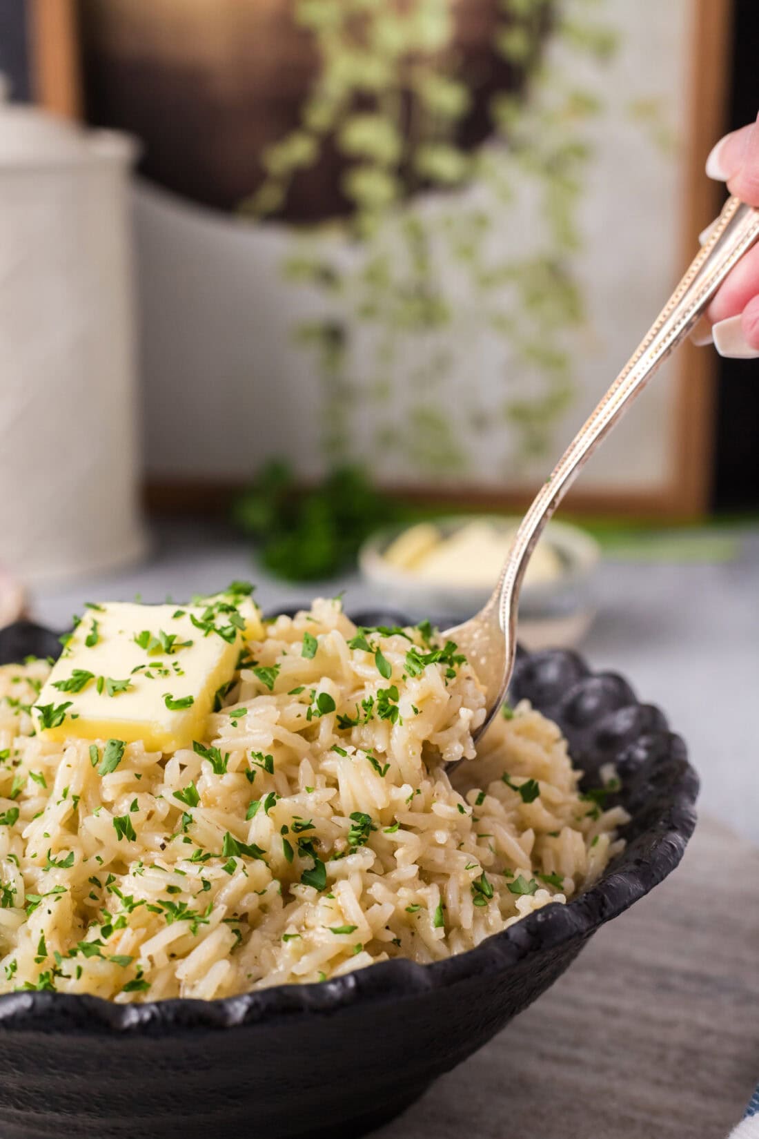 Spoon lifting Garlic Butter Rice out of a bowl