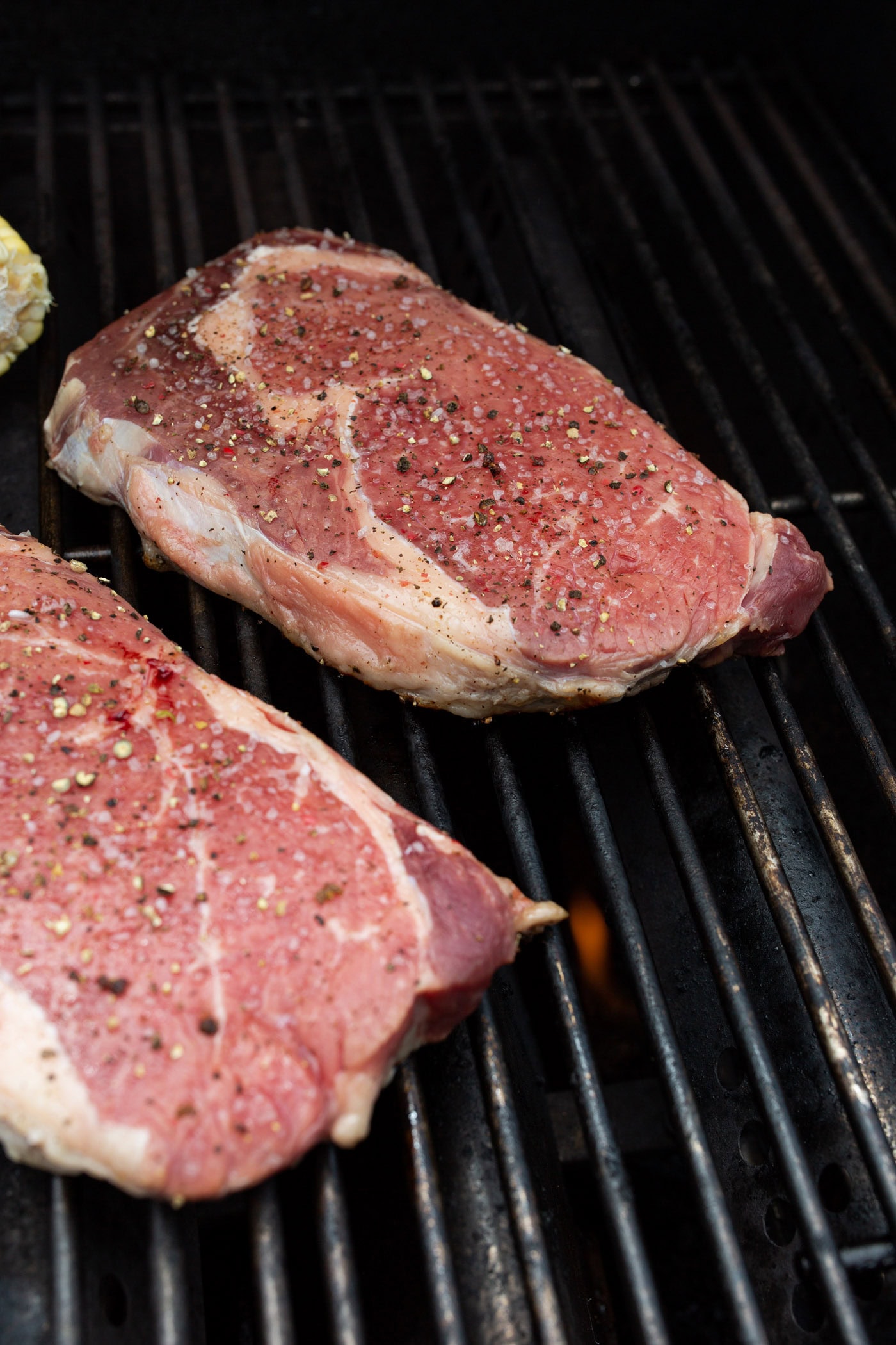 new york strip steaks on a grill