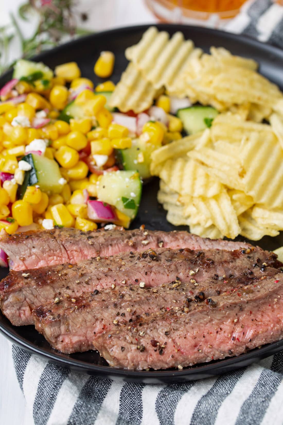 Grilled New York Strip Steak on a plate with corn
