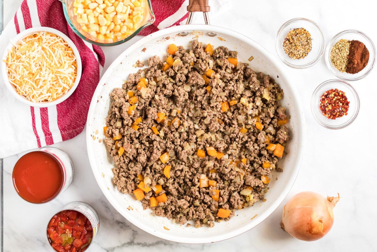 Browned ground beef and other needed ingredients to the side