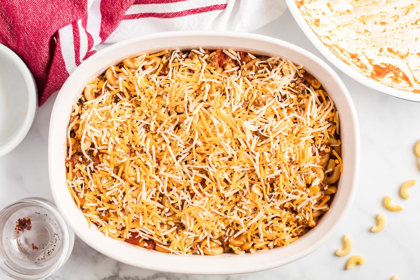 Ground beef casserole in a dish topped with cheese