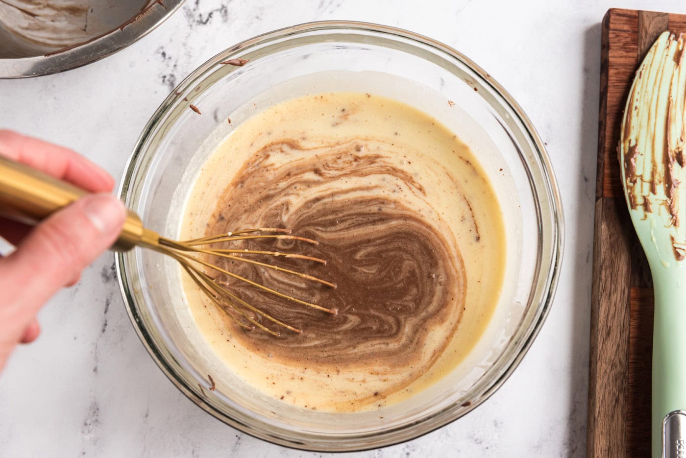 whisking chocolate mixture into egg mixture