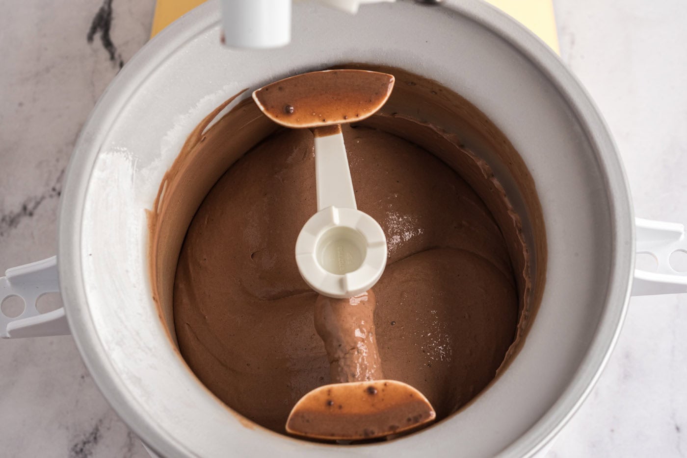 churning chocolate ice cream in an ice cream maker