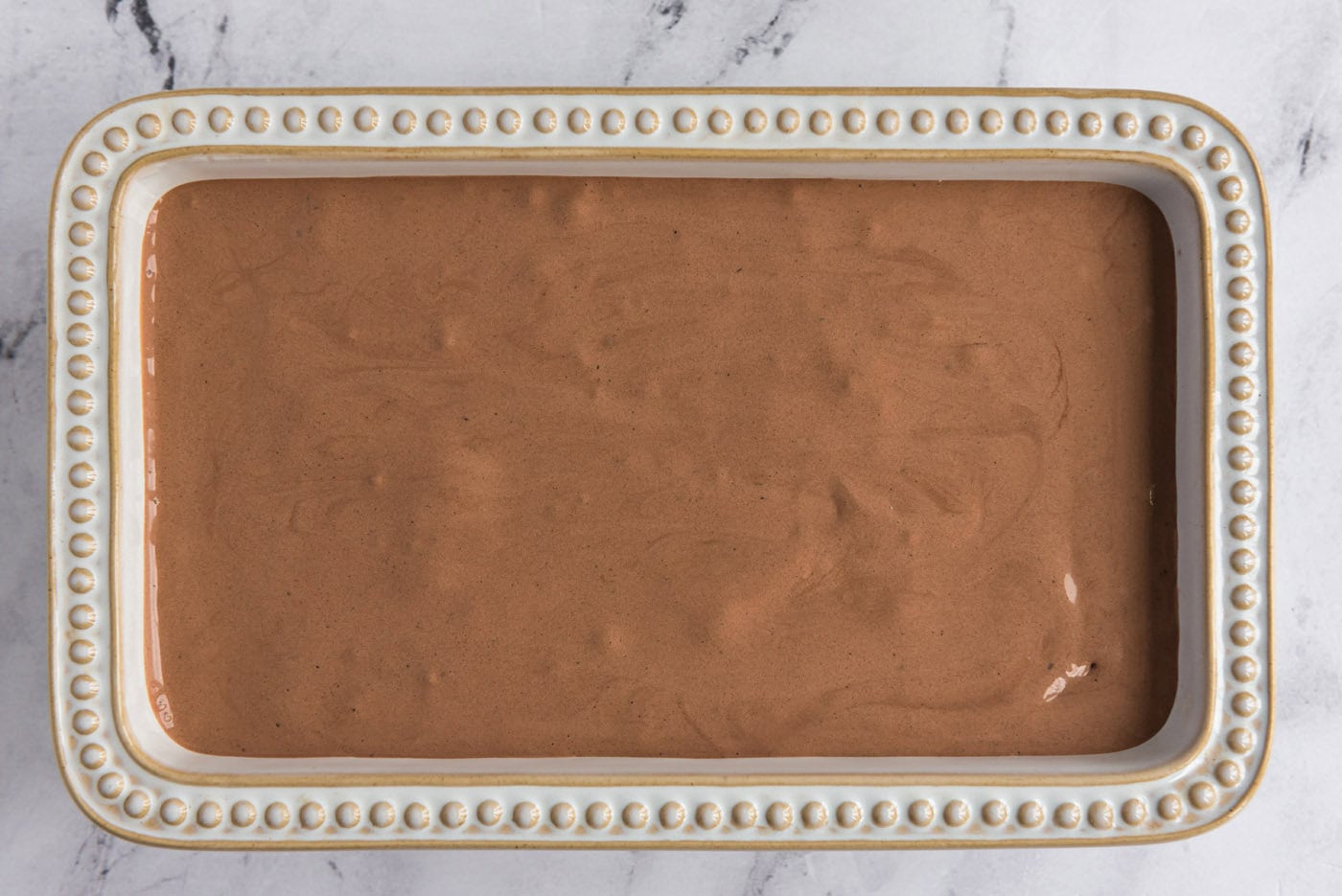 homemade chocolate ice cream mixture in a loaf pan