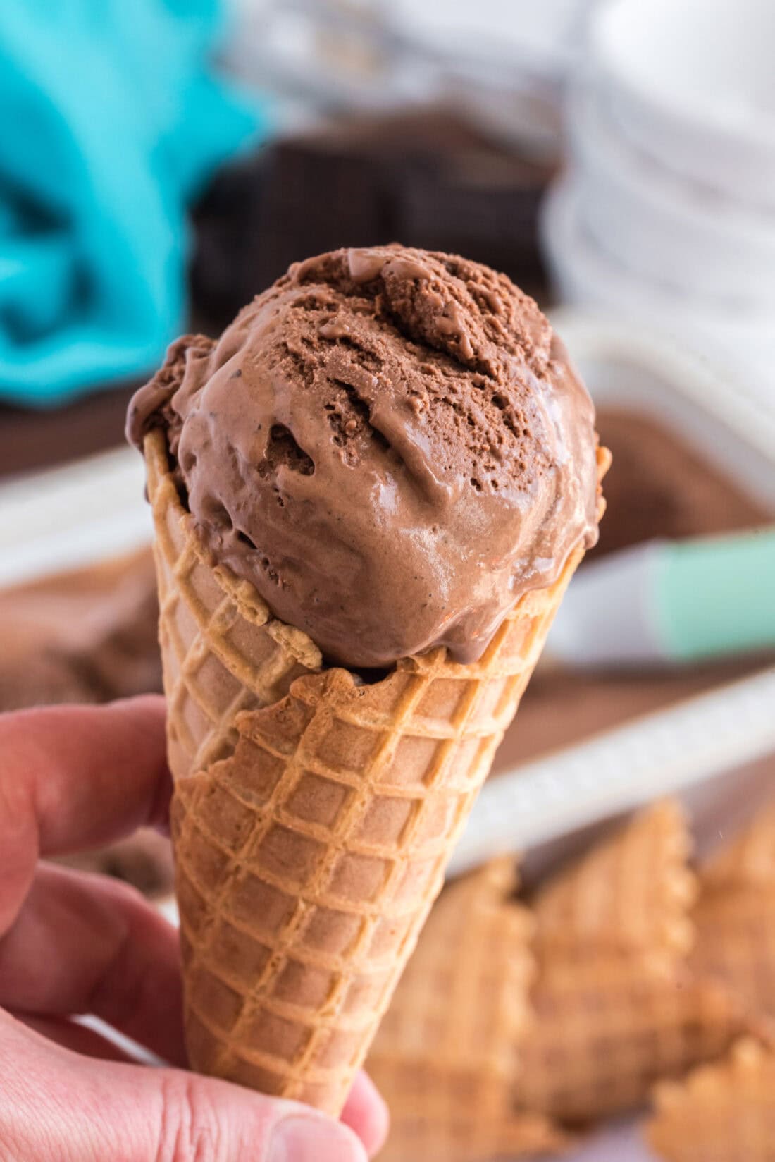 Hand holding a cone of Homemade Chocolate Ice Cream