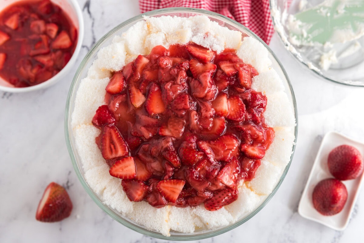 layer of macerated strawberries on top of strawberry shortcake trifle