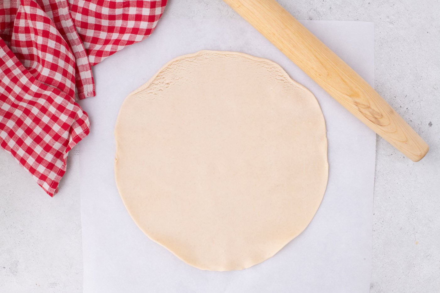 pie dough rolled out with a rolling pin