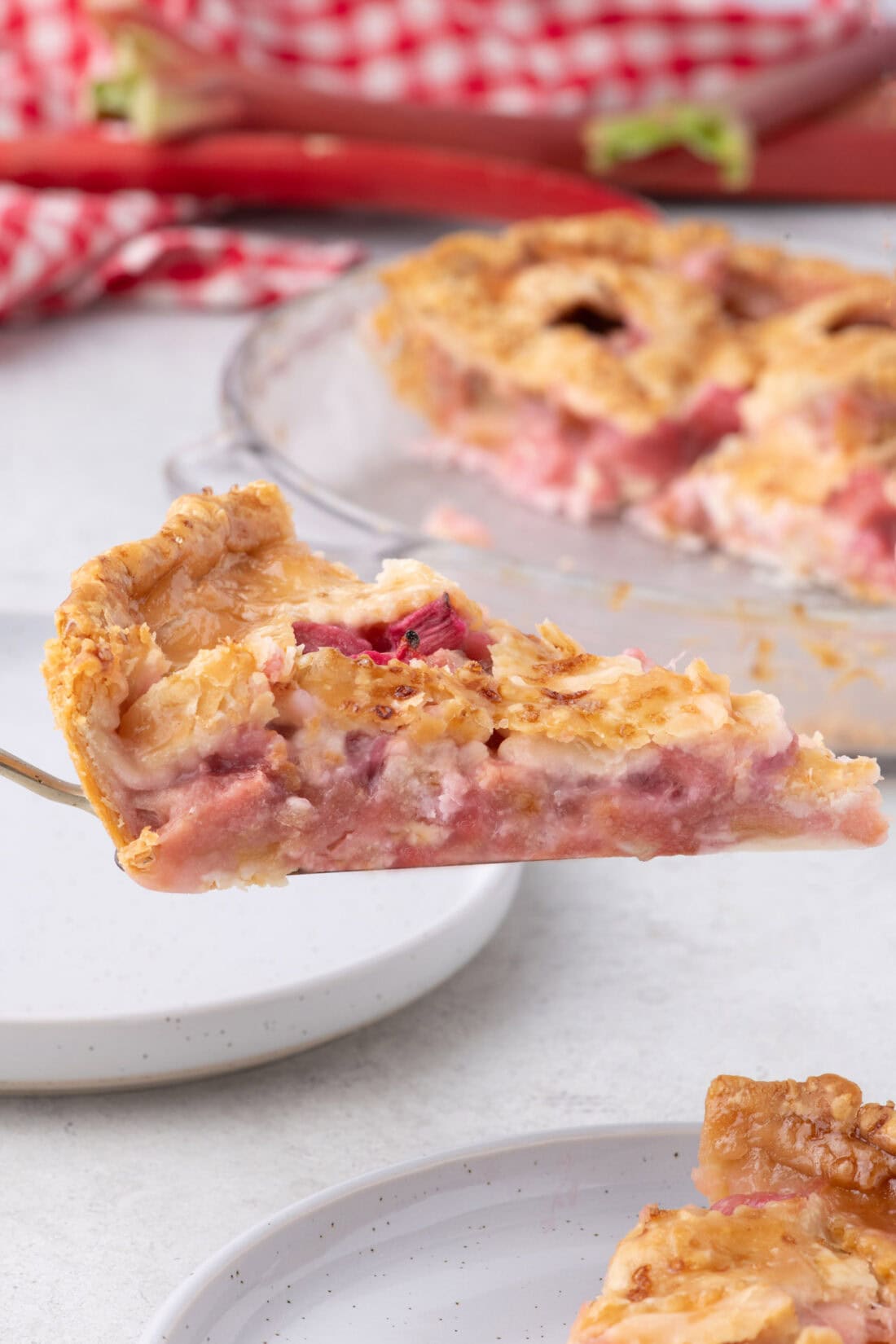 Slice of Rhubarb Pie lifted up on a pie server