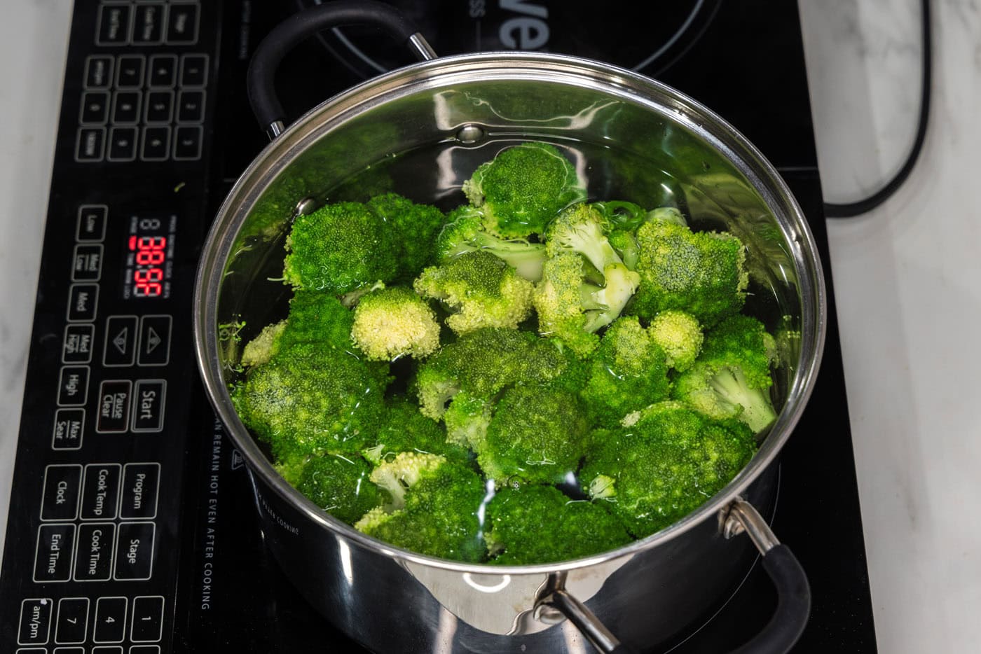 broccoli florets in a pot of water