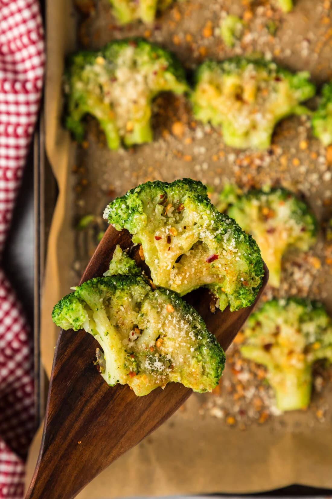 Two Smashed Broccoli pieces on a spatula