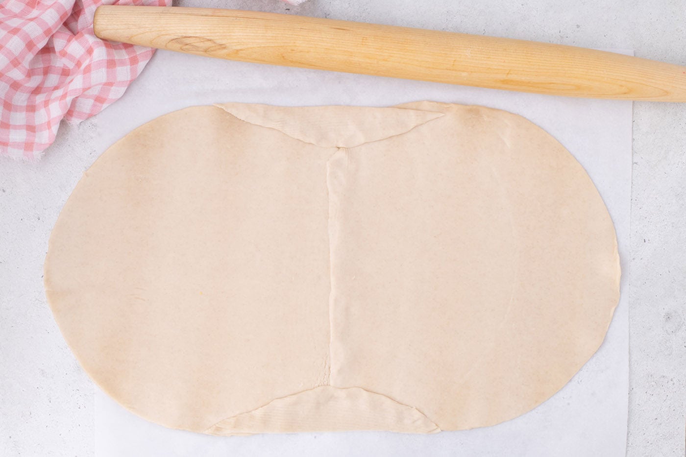 joining two pie crusts together with a rolling pin