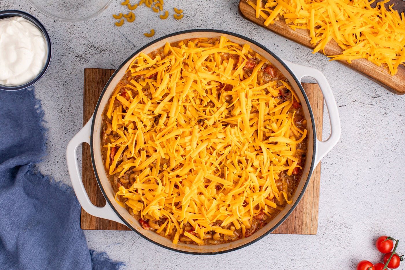 shredded cheddar cheese on top of taco mac