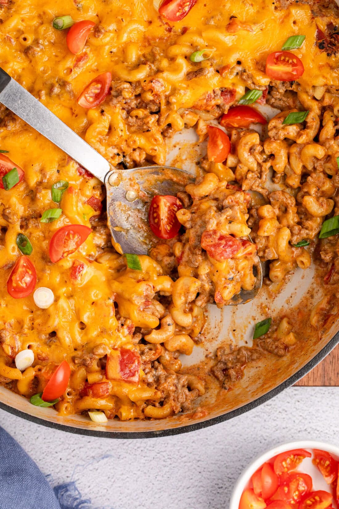 Close up photo of a spoon in a skillet of Taco Macaroni and Cheese