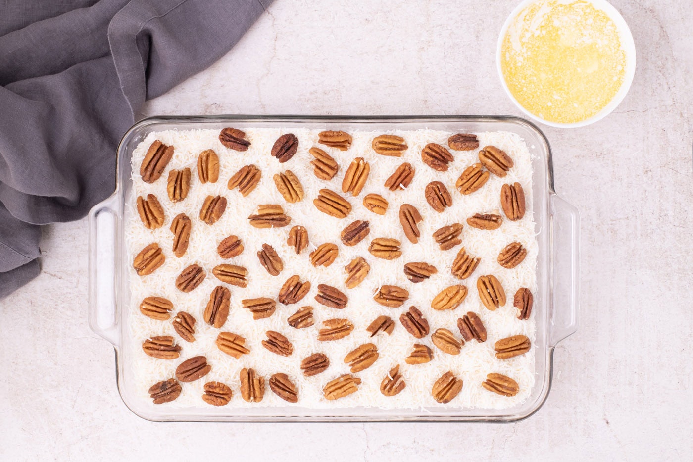 pecans on top of shredded coconut and dump cake mix in a baking dish