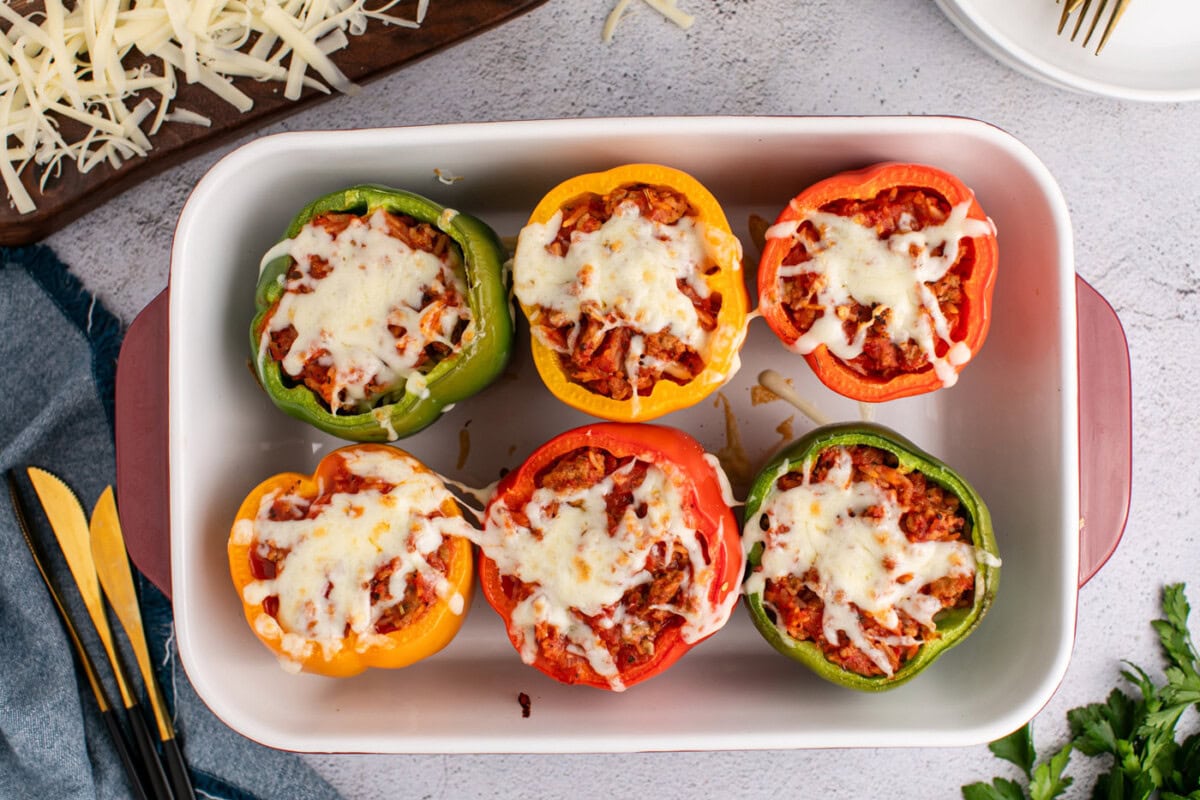baked turkey stuffed peppers in a casserole dish