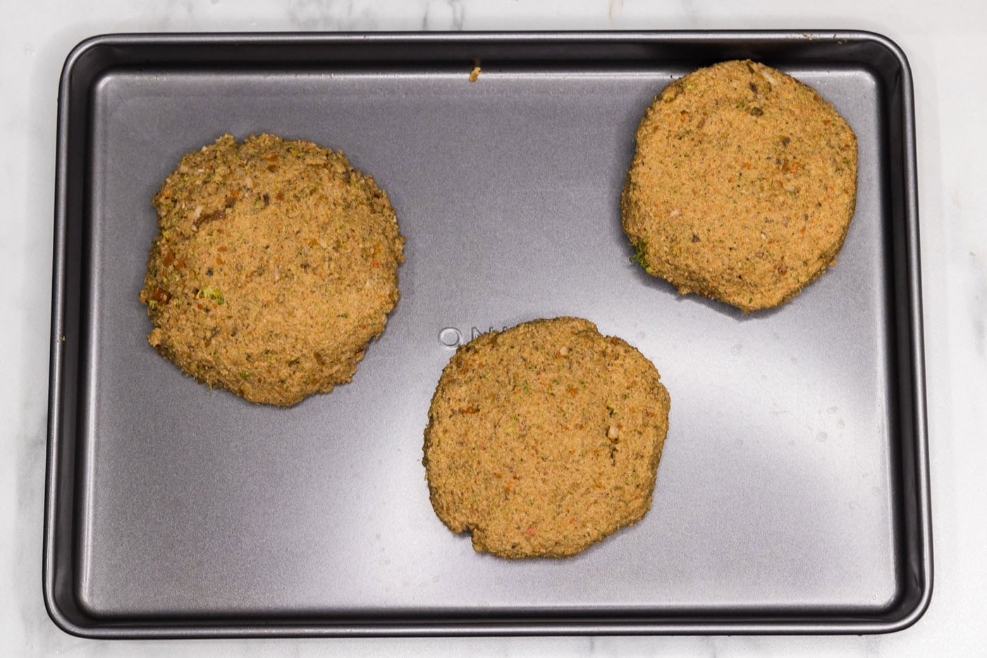 veggie burger patties on a baking sheet
