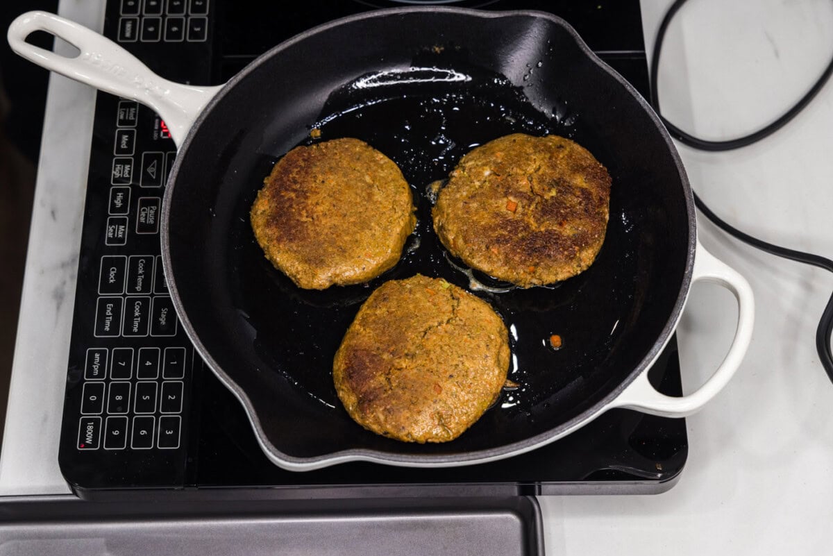 cooking veggie burger patties in a skillet