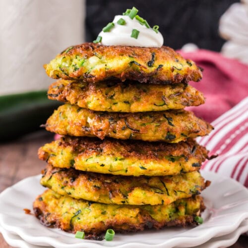 Close up photo of a stack Zucchini Fritters on a plate
