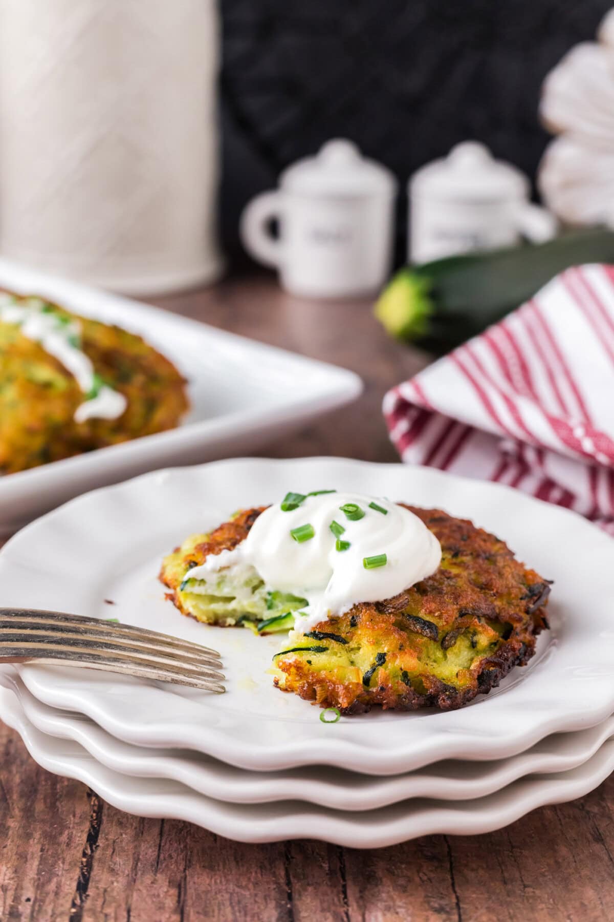 Zucchini Fritter on a plate with a piece removed